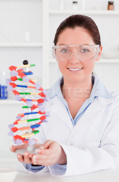 Portrait of a cute scientist showing the dna double helix model Stock photo © wavebreak_media