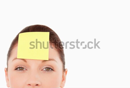 Young woman with a sign on her forehead against a white background Stock photo © wavebreak_media