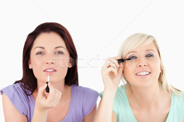 Pretty Women applying make-up in a studio Stock photo © wavebreak_media