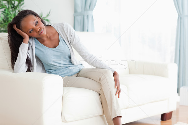 Young woman on sofa in thoughts Stock photo © wavebreak_media