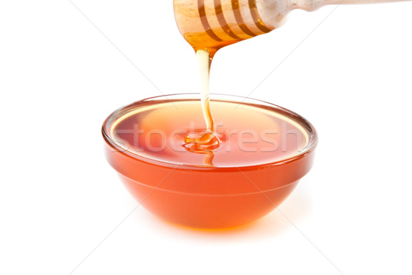 Honey trickle dropping in honey bowl Stock photo © wavebreak_media