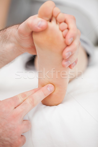 Doctor massaging the ball of the foot in a room Stock photo © wavebreak_media