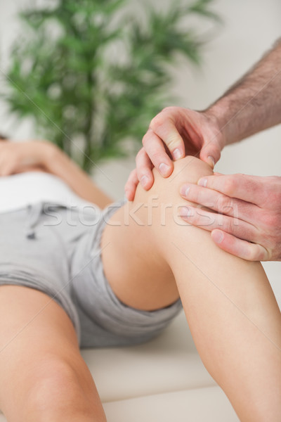 Fingers of a doctor massaging a leg in a room Stock photo © wavebreak_media
