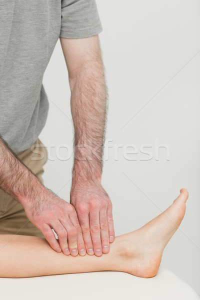 Fingertips massaging a shin bone in a room Stock photo © wavebreak_media
