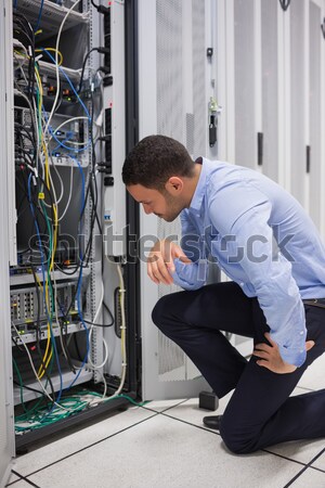 Technician kneeling and repairing a server Stock photo © wavebreak_media