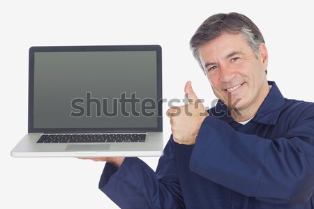 Mechanic with laptop showing thumbs up sign Stock photo © wavebreak_media