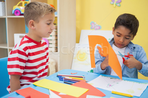 Cute little boys cutting paper shapes in classroom Stock photo © wavebreak_media