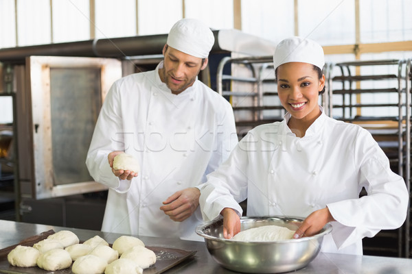 Stock photo: Team of bakers preparing dough