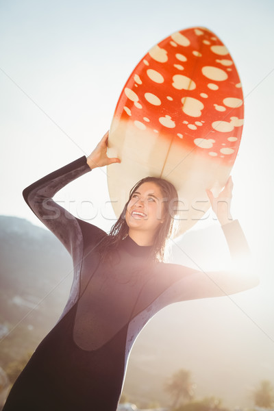 woman in wetsuit with a surfboard on a sunny day Stock photo © wavebreak_media