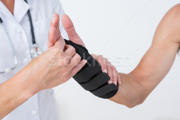 Doctor examining a man wrist Stock photo © wavebreak_media
