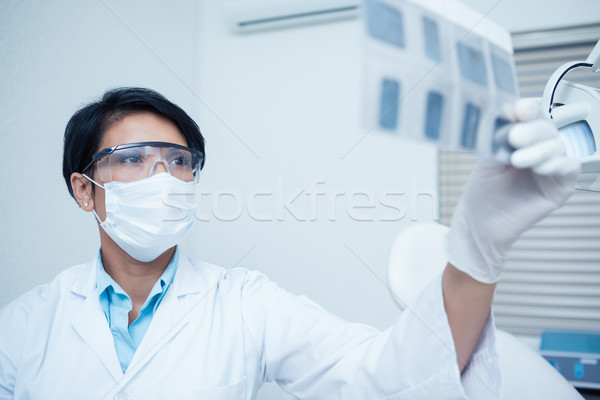 Stock photo: Concentrated dentist looking at x-ray