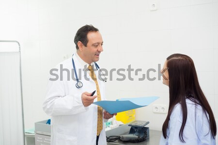 Biologist giving blood sample to his colleague Stock photo © wavebreak_media