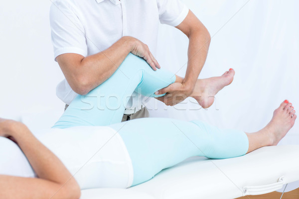 Physiotherapist doing leg massage to his patient Stock photo © wavebreak_media