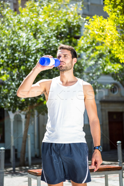 Handsome athlete drinking out of bottle Stock photo © wavebreak_media