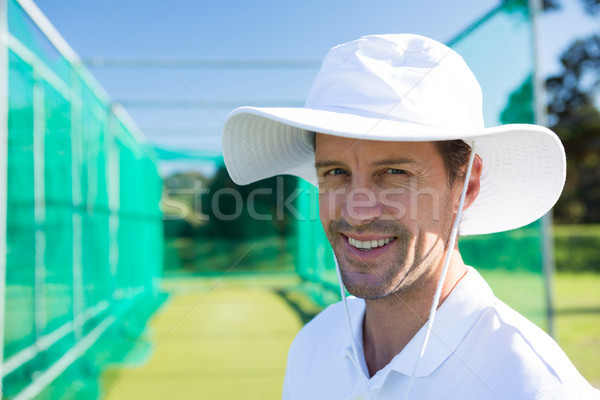 Portrait of smiling cricketer standing at field Stock photo © wavebreak_media
