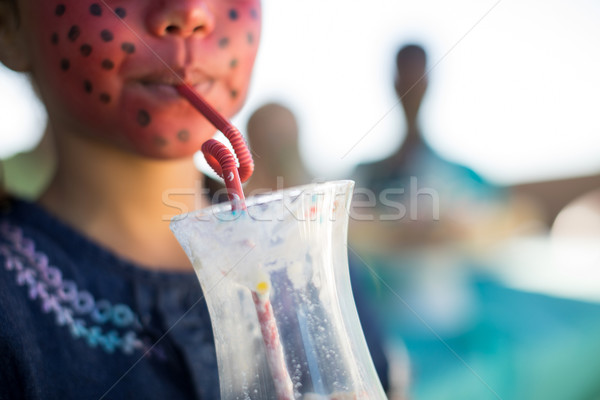 Girl with face paint having drink at park Stock photo © wavebreak_media