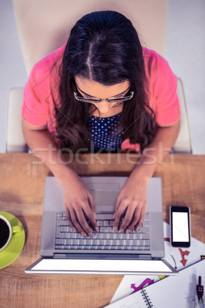 Overhead view of businesswoman typing on laptop keyboard Stock photo © wavebreak_media