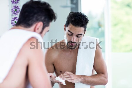 Unsmiling men in front of mirror  Stock photo © wavebreak_media