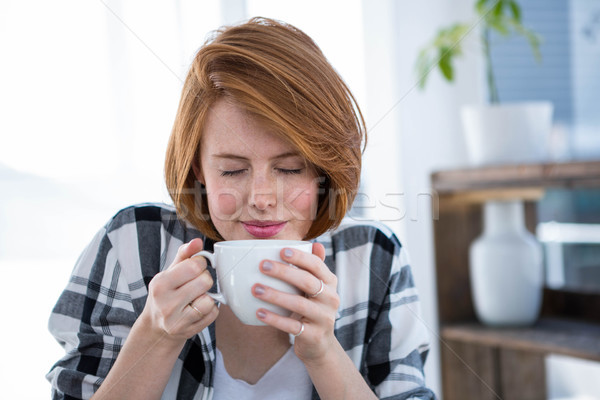 smiling hipster woman smelling a cup of coffee Stock photo © wavebreak_media