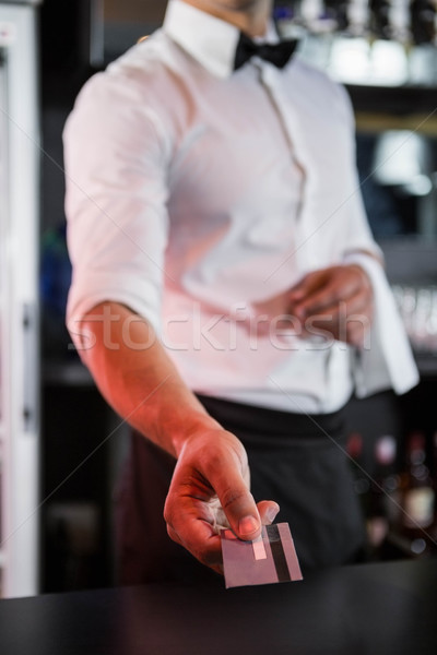 Bartender accepting a credit card at bar counter Stock photo © wavebreak_media