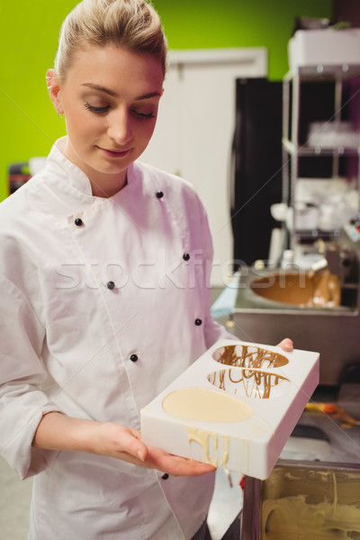 Worker holding chocolate filled mould Stock photo © wavebreak_media