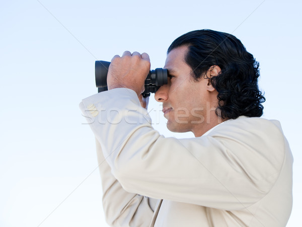 Portrait of a latin business man looking through binoculars Stock photo © wavebreak_media