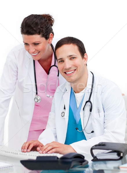 Two jolly doctors working at a computer Stock photo © wavebreak_media