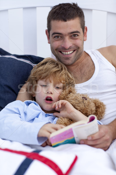 Father and son reading a book in bed Stock photo © wavebreak_media