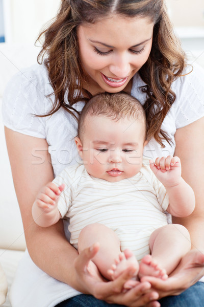 Pretty young mother taking care of her adorable baby Stock photo © wavebreak_media