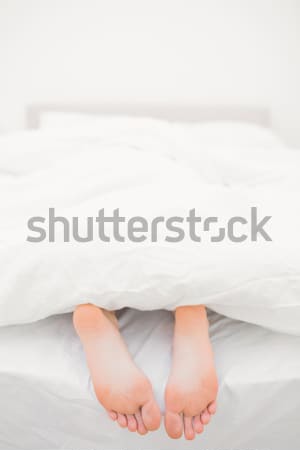Close up of couple's feet while hugging in their bed at home Stock photo © wavebreak_media