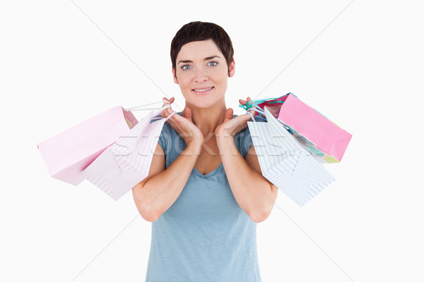 Aranyos nő tart bevásárlótáskák fehér mosoly Stock fotó © wavebreak_media