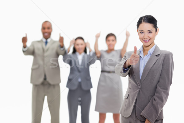 Businesswoman approving with approving co-workers in the background Stock photo © wavebreak_media