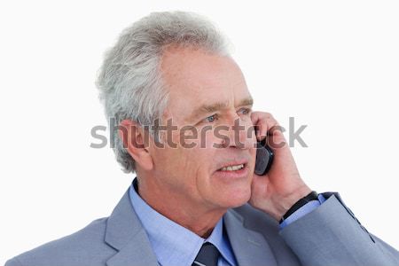 Close up of mature tradesman listening to caller against a white background Stock photo © wavebreak_media