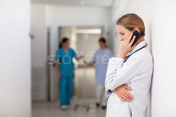 Woman doctor phoning on the hallway in a hallway Stock photo © wavebreak_media