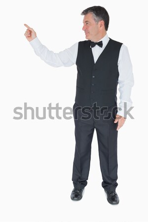 Foto stock: Sonriendo · camarero · traje · senalando · algo · mano