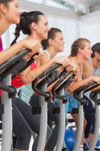 Stock photo: Fit people working out at spinning class