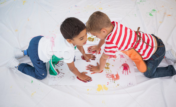 Cute little boys painting on floor in classroom Stock photo © wavebreak_media