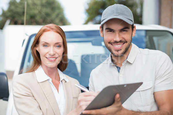 Delivery driver showing where to sign to customer Stock photo © wavebreak_media