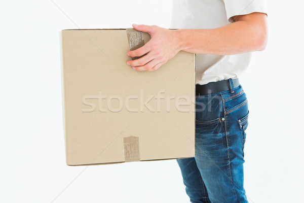 Delivery man carrying cardboard box Stock photo © wavebreak_media