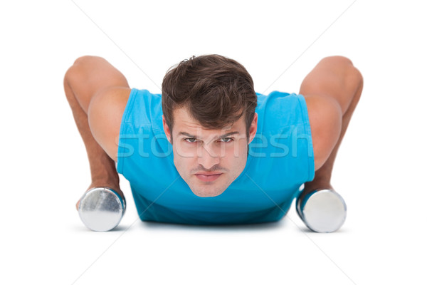 Fit man doing push ups with dumbbells Stock photo © wavebreak_media