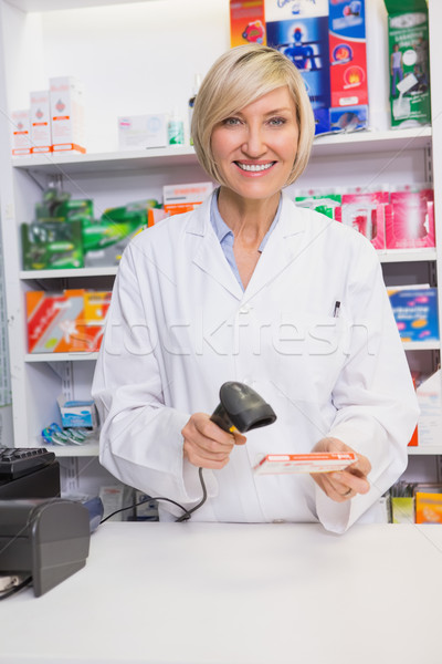 Smiling pharmacist scanning box of medicine Stock photo © wavebreak_media