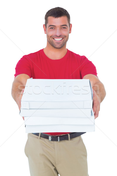 Happy delivery man giving pizza boxes Stock photo © wavebreak_media