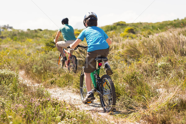 Father and son biking through mountains Stock photo © wavebreak_media