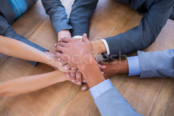 Business people joining hands in a circle Stock photo © wavebreak_media
