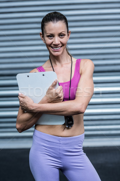 Lächelnd weiblichen Trainer Zwischenablage Stoppuhr Porträt Stock foto © wavebreak_media