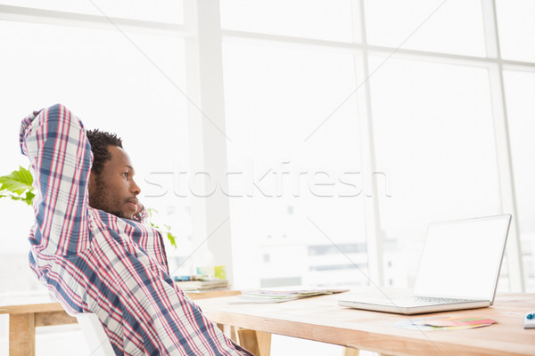 Young businessman relaxing at his desk Stock photo © wavebreak_media