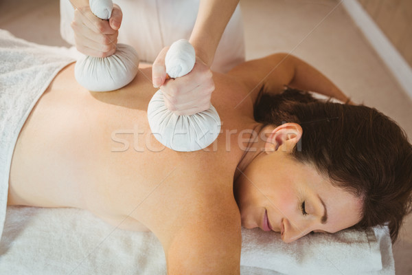 Young woman getting herbal compress massage Stock photo © wavebreak_media