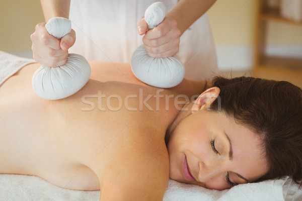 Young woman getting herbal compress massage Stock photo © wavebreak_media