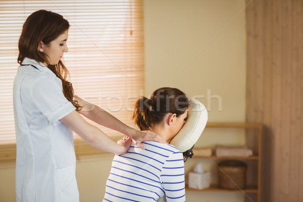 Young woman getting massage in chair Stock photo © wavebreak_media