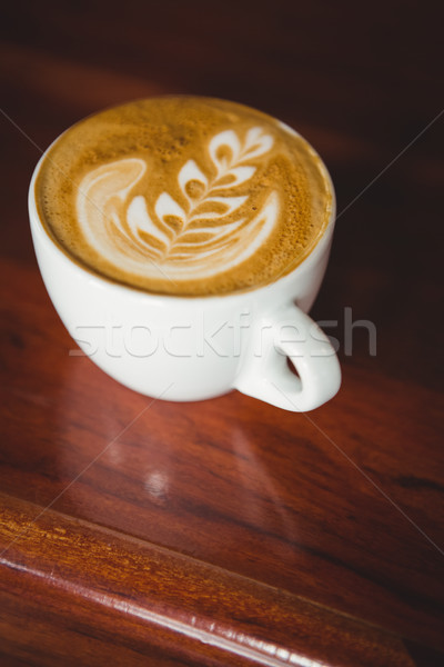 Cup of cappuccino with coffee art on the counter Stock photo © wavebreak_media